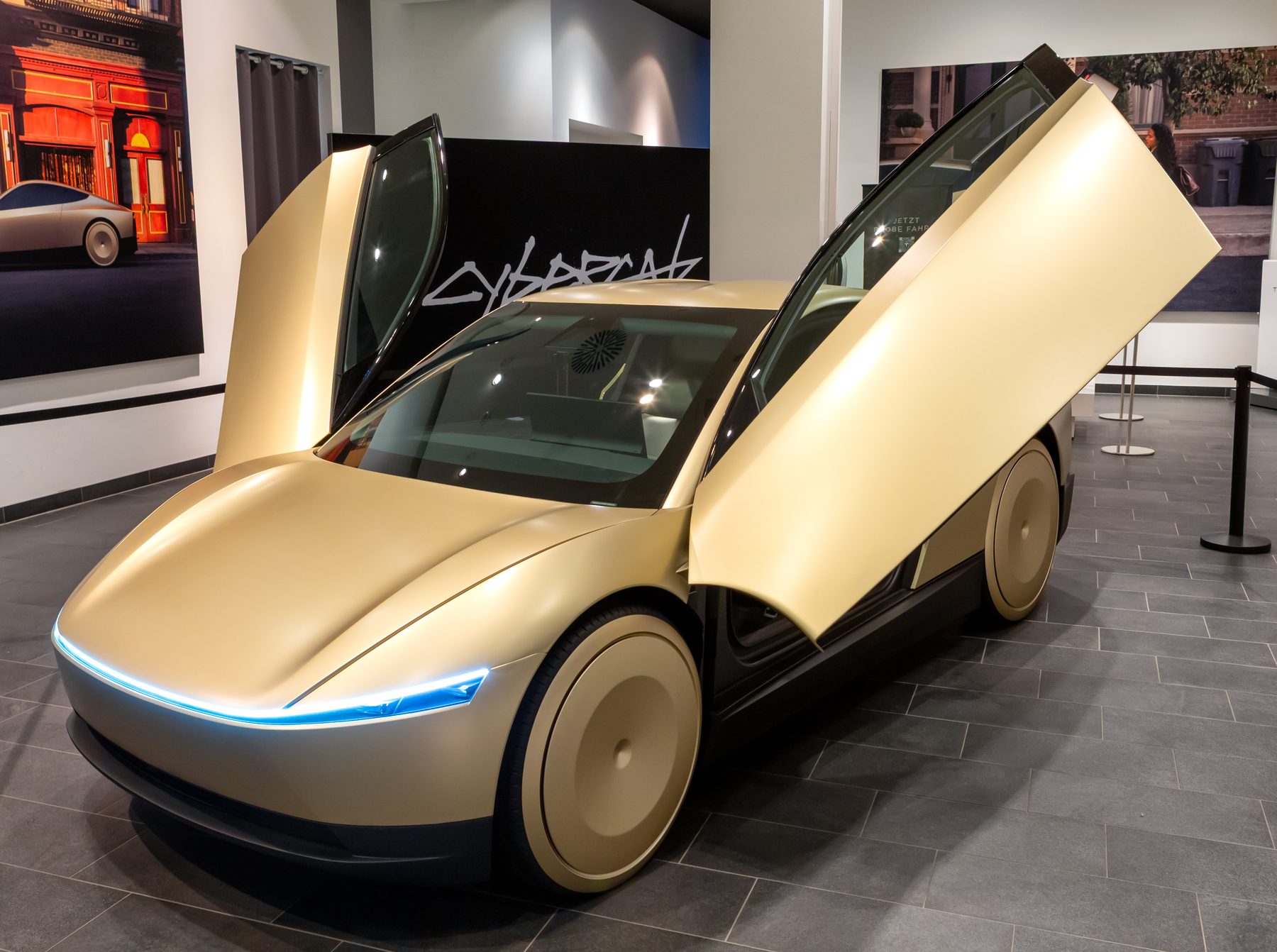 Tesla Cybercab, the two-seat driverless car, on display with its doors raised